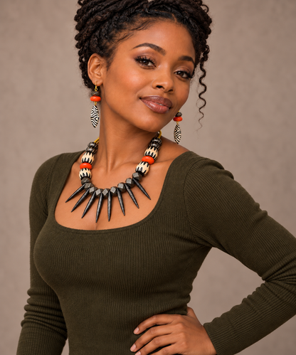 Model wearing the Ember Batik Statement Necklace and matching earrings with an olive fall top.