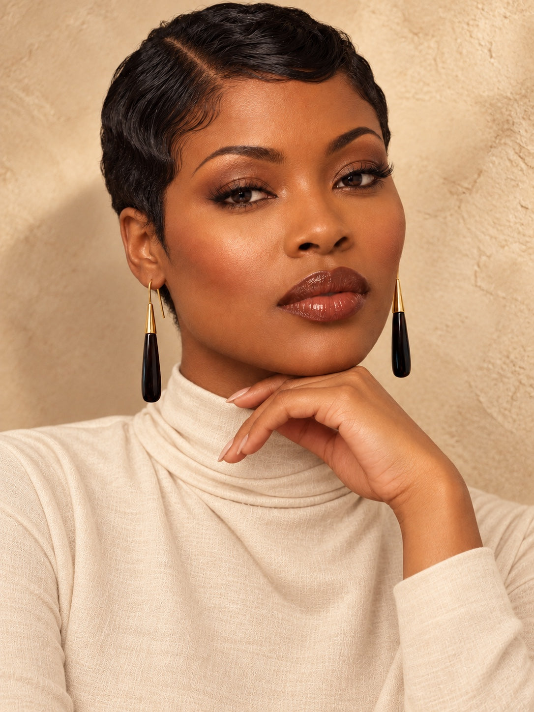 Model wearing the Noir Taper Earrings in polished black cow horn and brass